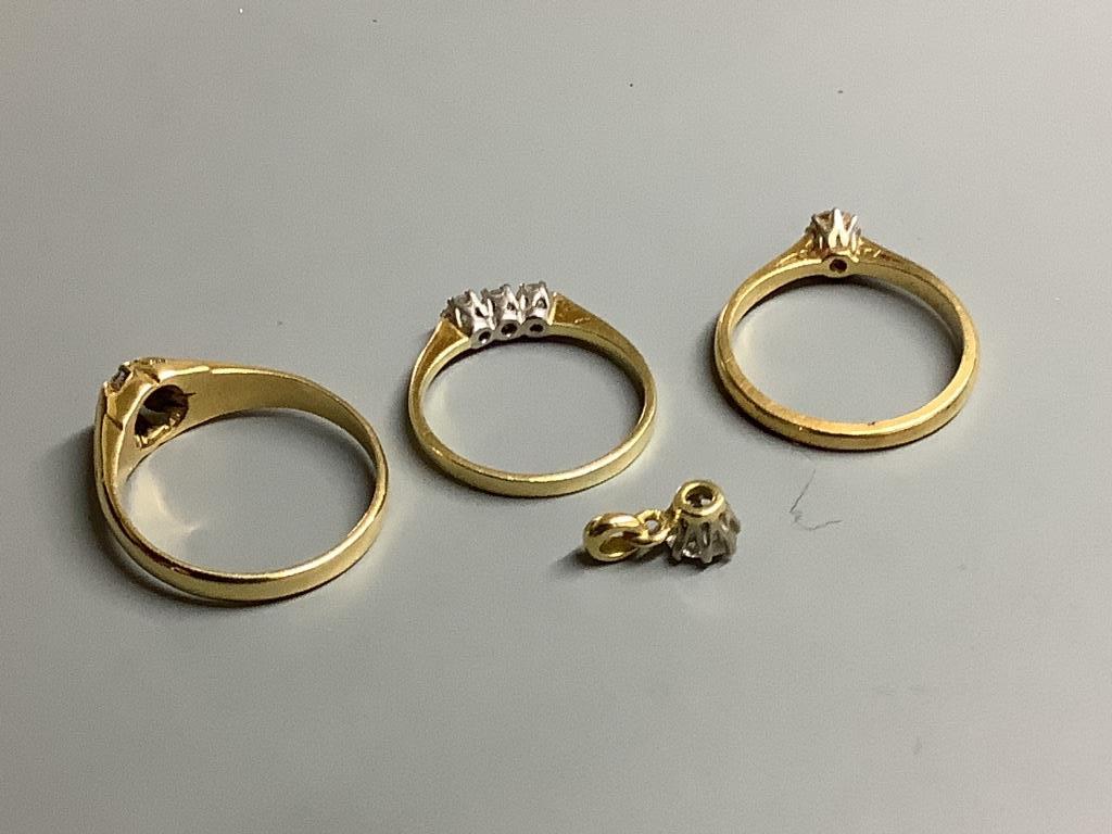 Three assorted 18 carat gold and diamond set dress rings, gross 8.3 g and yellow metal and diamond set small pendant, gross 0.7 g.